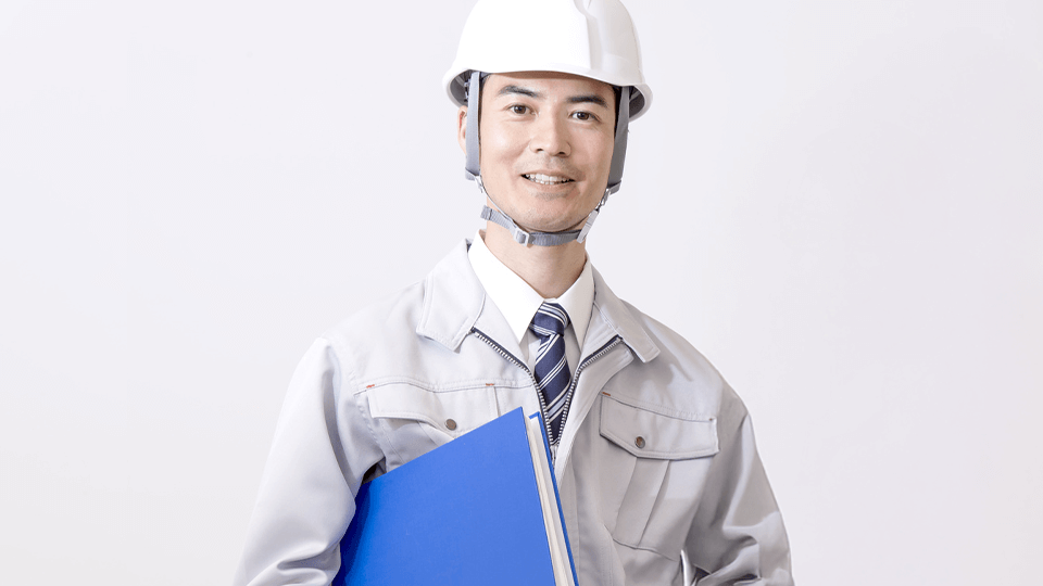 作業着とヘルメットを着用している日本人男性の画像